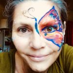 adult with half butterfly face painting