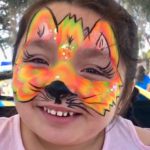 kid with orange kitty facepaint