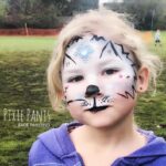 outdoor fun party kid with white kitty face painting