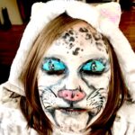 Kid with snow leopard face paint